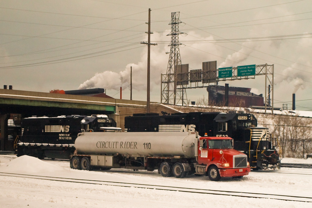 Tanker truck alongside cargo train in Canada