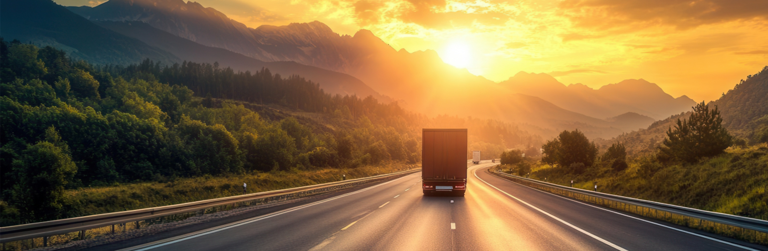 Semi trucks driving on scenic forest highway during warm sunset